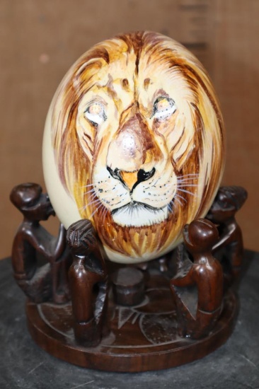 Hand-painted OSTRICH EGG Featuring a Lion on a Wood Stand with Carved African Figures