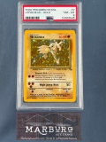 PSA 8 Hitmonlee Fossil Base set- Holo Pokemon