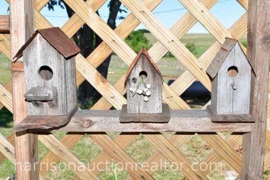 three assorted, handmade, bird houses with tin roofs