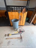 Trash can, pick ax, sledgehammer, shovels, jumper cables, work light