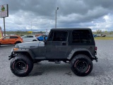 1990 Jeep Wrangler 4x4 SUV.6 cylinder, manual transmission.Gray with tan in