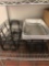 Miscellaneous food warming items ,table cloths and food service trays (contents only of bottom shelf