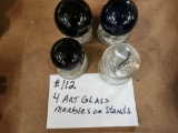 4 ART GLASS MARBLES ON STANDS LOT