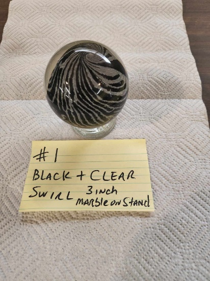 Black and clear 3 inch Art Glass marble on base