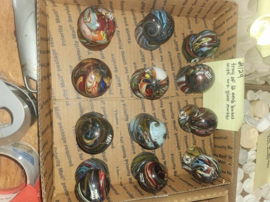 Tray of 12 Art glass marbles with Emb bases