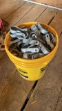Bucket of chain-link fence post brackets