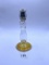 Candle stand with a little bit of liquid Avon bottle