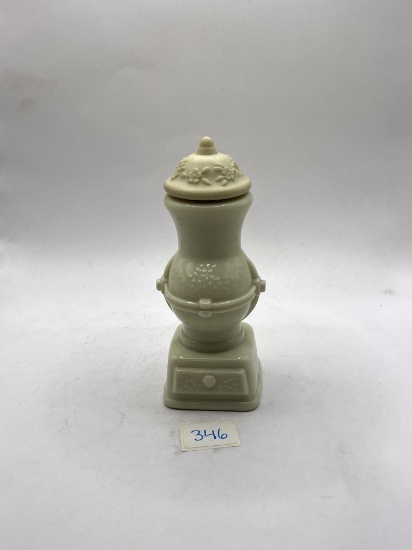 White statue with liquid Avon bottle