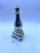 Candle stand with some liquid Avon bottle
