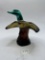 Mallard-in-flight with liquid Avon bottle