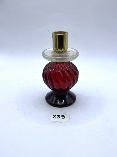 Candle stand with some liquid Avon bottle
