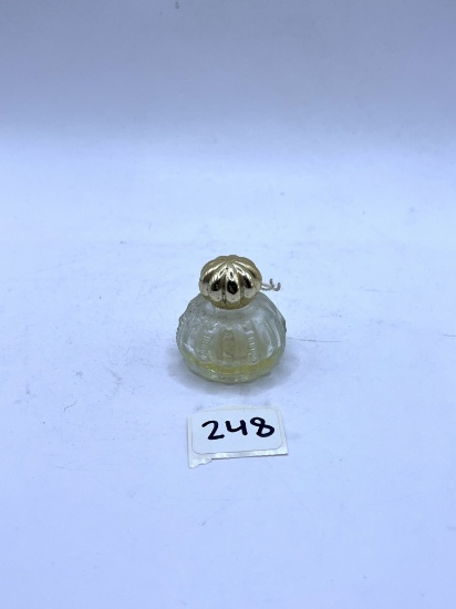Small clear with some liquid Avon bottle