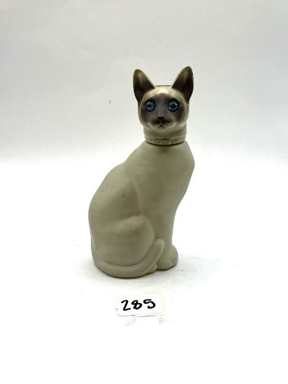 Cat with some liquid Avon bottle