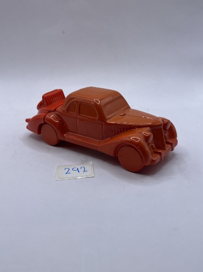 Orange car with some liquid Avon bottle