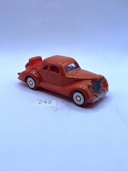 Orange car with some liquid Avon botte