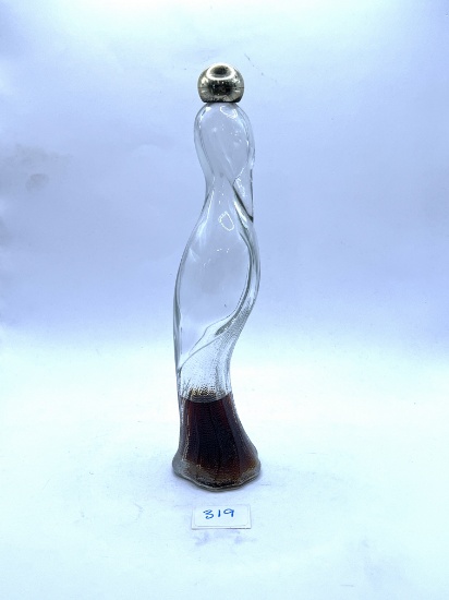 Flamingo decanter with some liquid Avon bottle