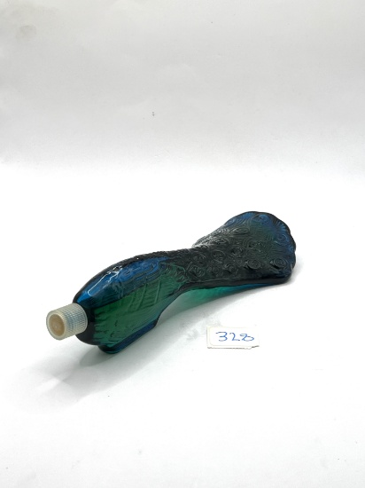 Peacock tail with some liquid Avon bottle