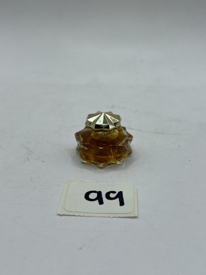 Rapture tiny perfume with some liquid Avon bottle