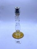 Candle stand with a little bit of liquid Avon bottle