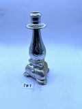 Candle stand with some liquid Avon bottle