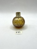 Brown round Avon bottle