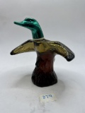 Mallard-in-flight with liquid Avon bottle