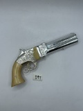 White revolver Avon bottle