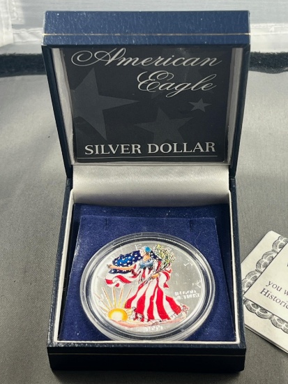 Painted 1999 US Silver Eagle coin in presentation box, .999 silver