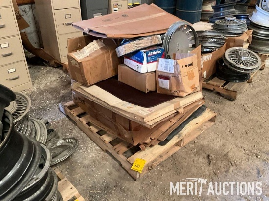 Pallet of hub caps, floor mats, AC Delco parts