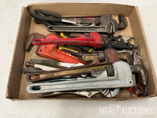 Assortment of pipe wrenches and plyers