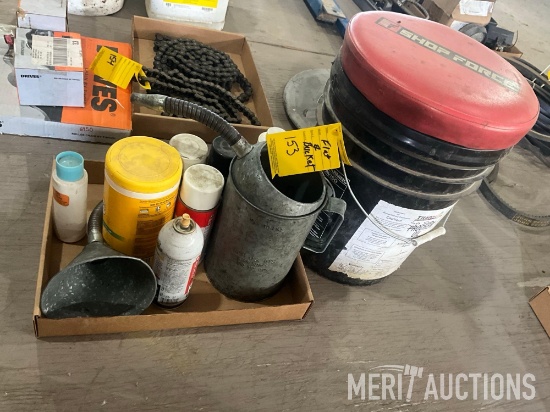 flat of oil cans, shop fluids, and a bucket