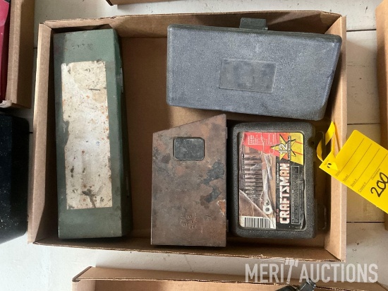 flat of small tools, drill bits, and impact sockets