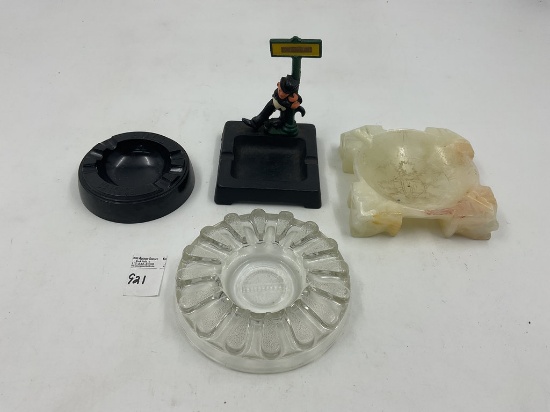 4 misc - Cast iron drunkman - marble aztec design - hull ashtray - glass clear tray