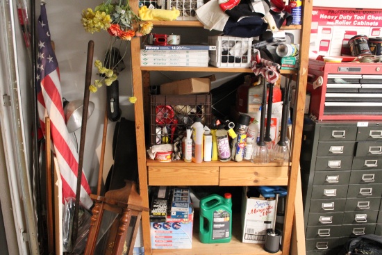 Shelf full of car care items, wood working kits, flags in the corner, the shelf and box’s of cedar w