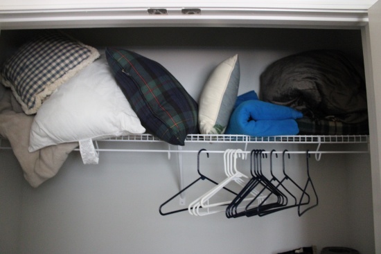 Closet Contents,pillows, blankets, rolled up area rugs, hangers and other items