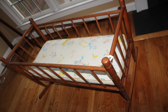 Wood Spindle rocking mini crib.