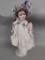 Porcelain Doll with Victorian-Style Outfit and Ribbon Accents