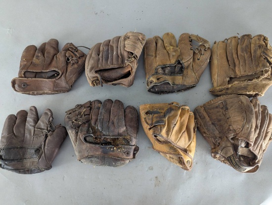 Eight Vintage Baseball Gloves in Various Conditions