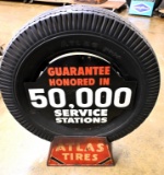 Atlas tire holder and advertising sign