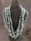 Group of Four Green Kyanite and Gold Tone Bead Necklaces