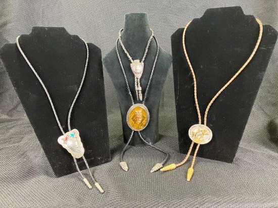 Group of Four Western Bolo Ties Featuring Leather, Snake Skin, and Mixed Metal