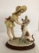 M. Marini Girl Putting a Hat on Her Dog Figurine