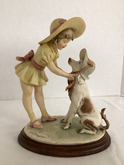 M. Marini Girl Putting a Hat on Her Dog Figurine