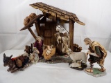 (7) PIECE ENORMOUS NATIVITY SCENE WITH PORCELAIN FIGURESAND WOODEN CRECHE