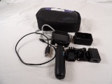 GOPRO KIT INCLUDING CAMERA, SLEEVE, HANDLE, AND CARRYING CASE.