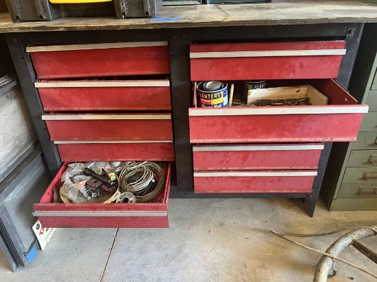 Contents of red tool box, including large drill bits