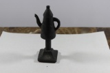 A Solid Metal Teapot on Stand