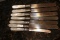 Lot of 7 Mother of Pearl and Sterling Ban Butter Knives