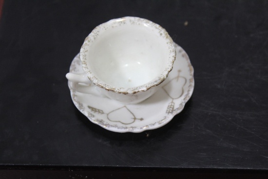 A Miniature Ceramic Cup and Saucer