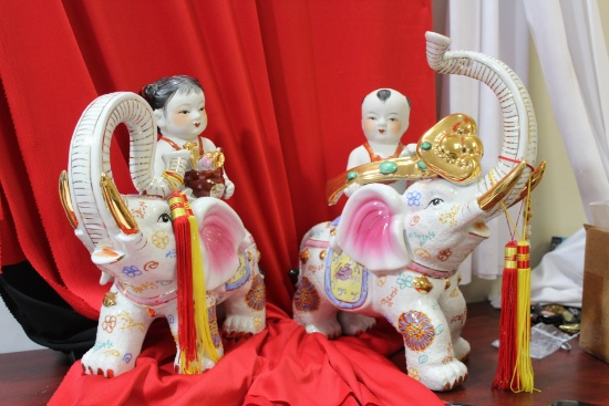 A Boy and Girl on Elephant Statues
